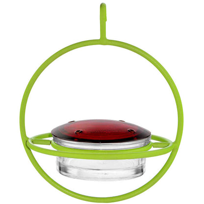 Hummingbird feeder with green rim and red top on a white background