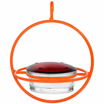 Hummingbird feeder with orange rim and clear base on a white background